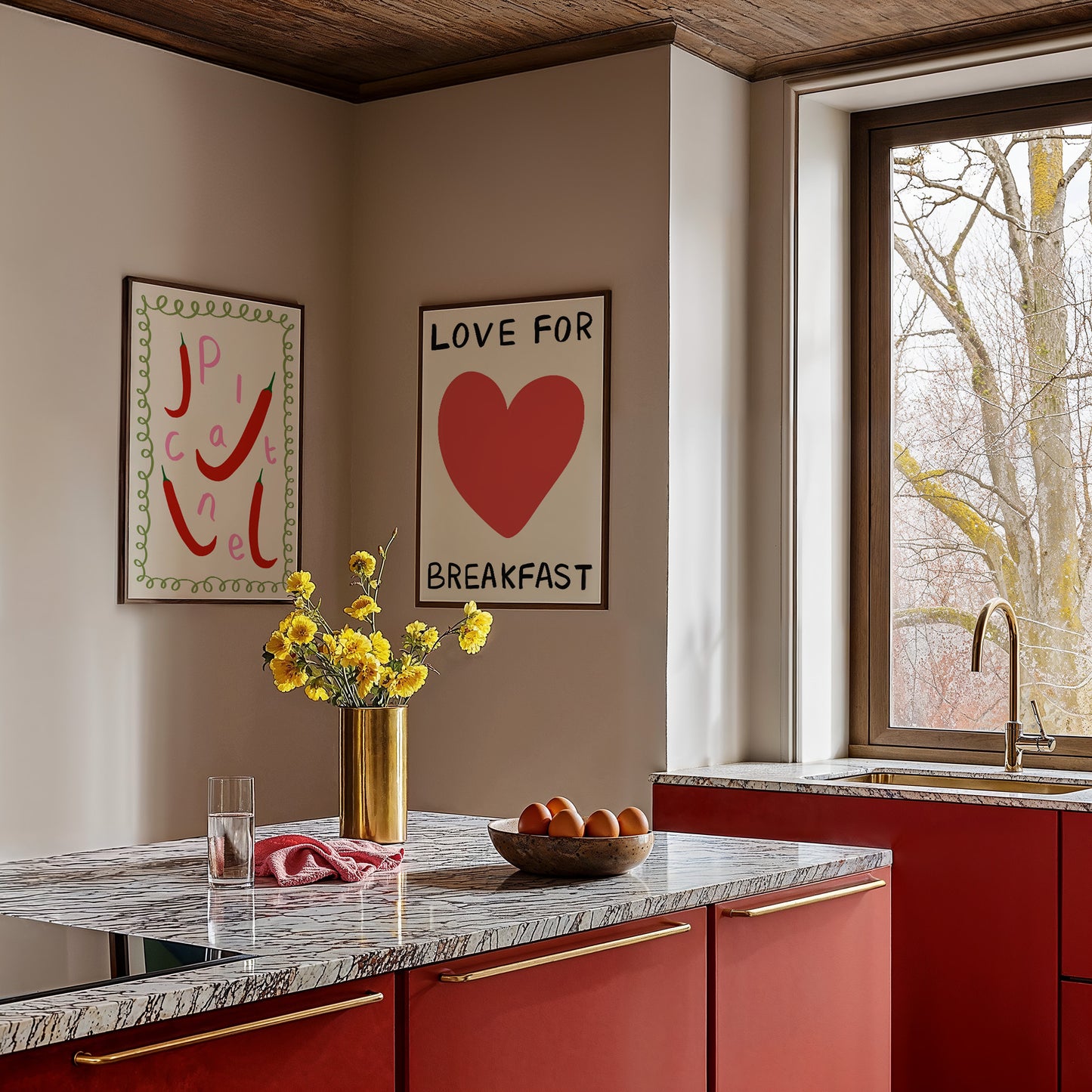 Modern kitchen with red cabinets, marble countertop, and decorative wall art.