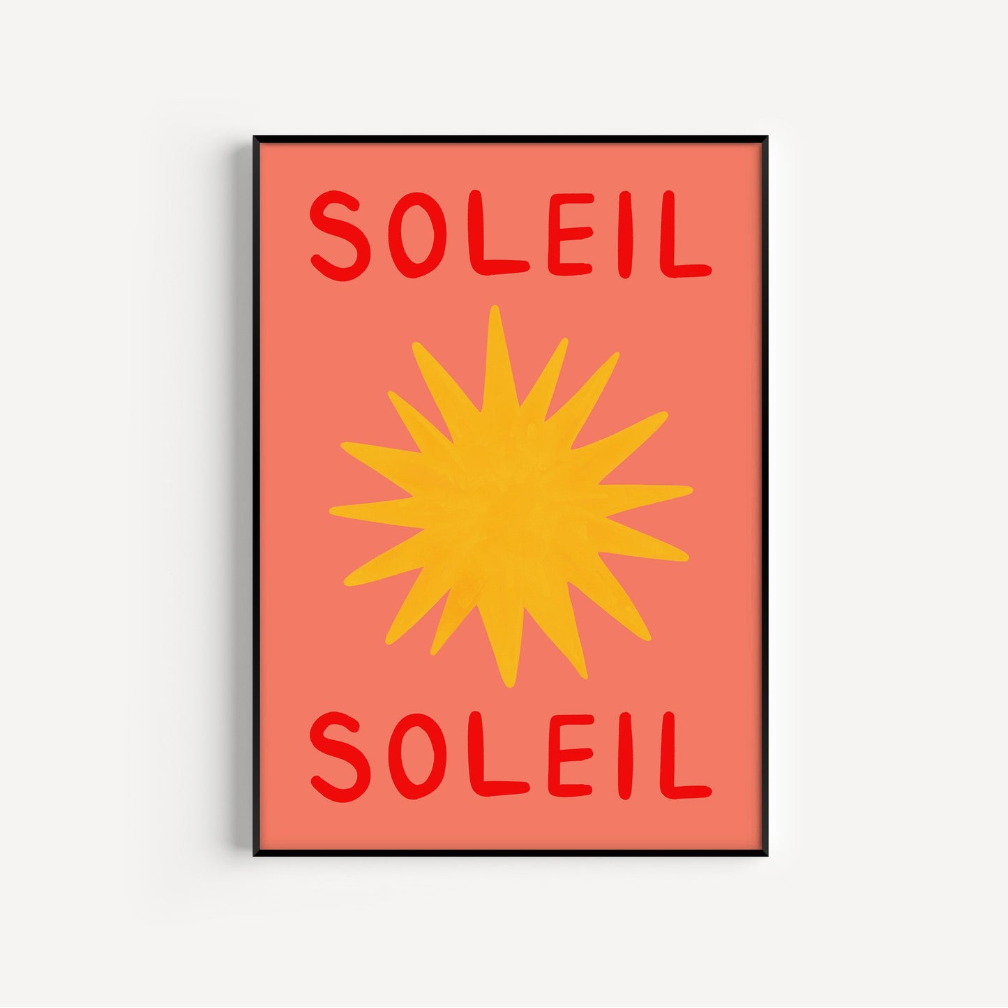 Framed artwork with 'Soleil' text and a yellow sun design on a red background.