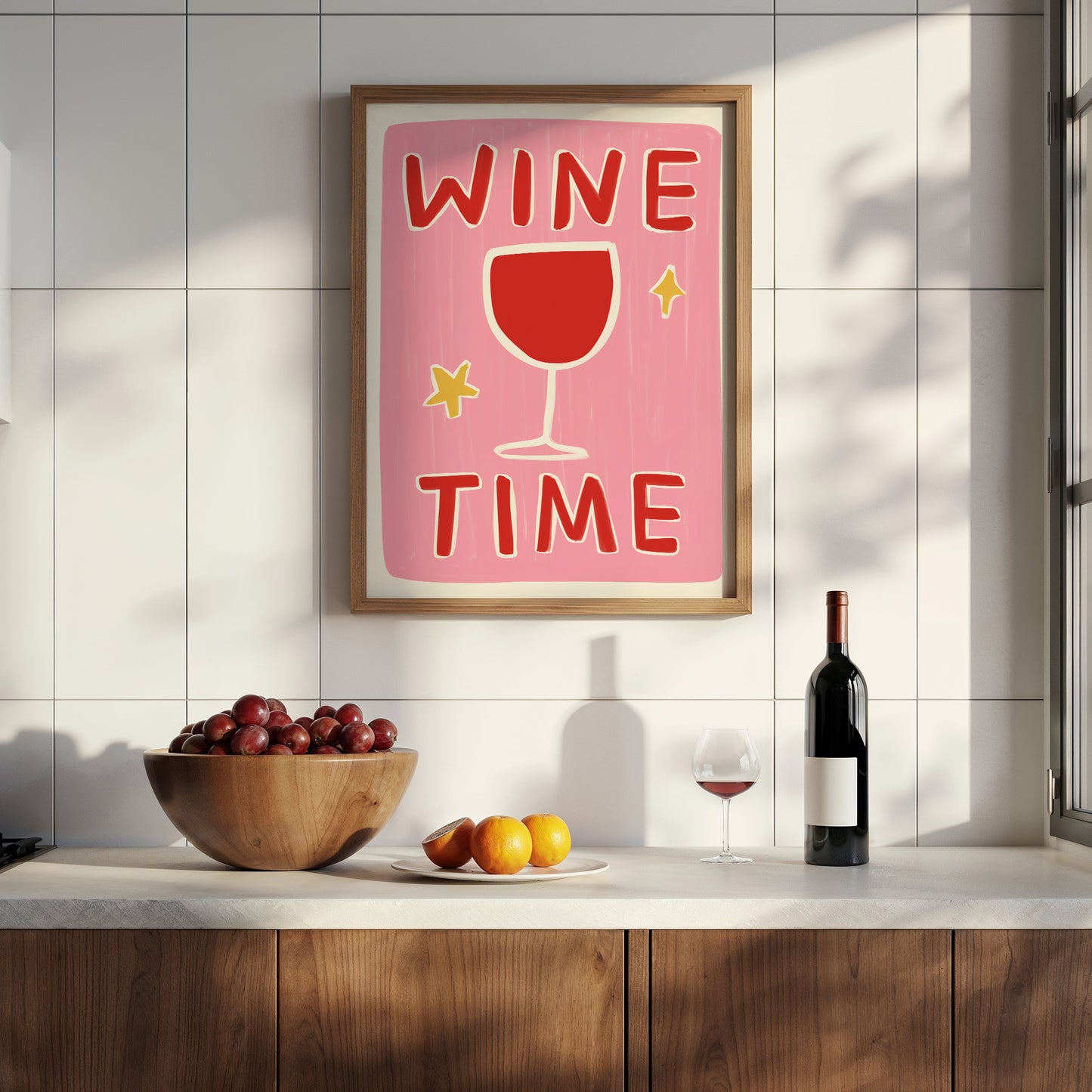 Framed 'Wine Time' poster on a kitchen wall with a bottle of wine and fruit bowl below.