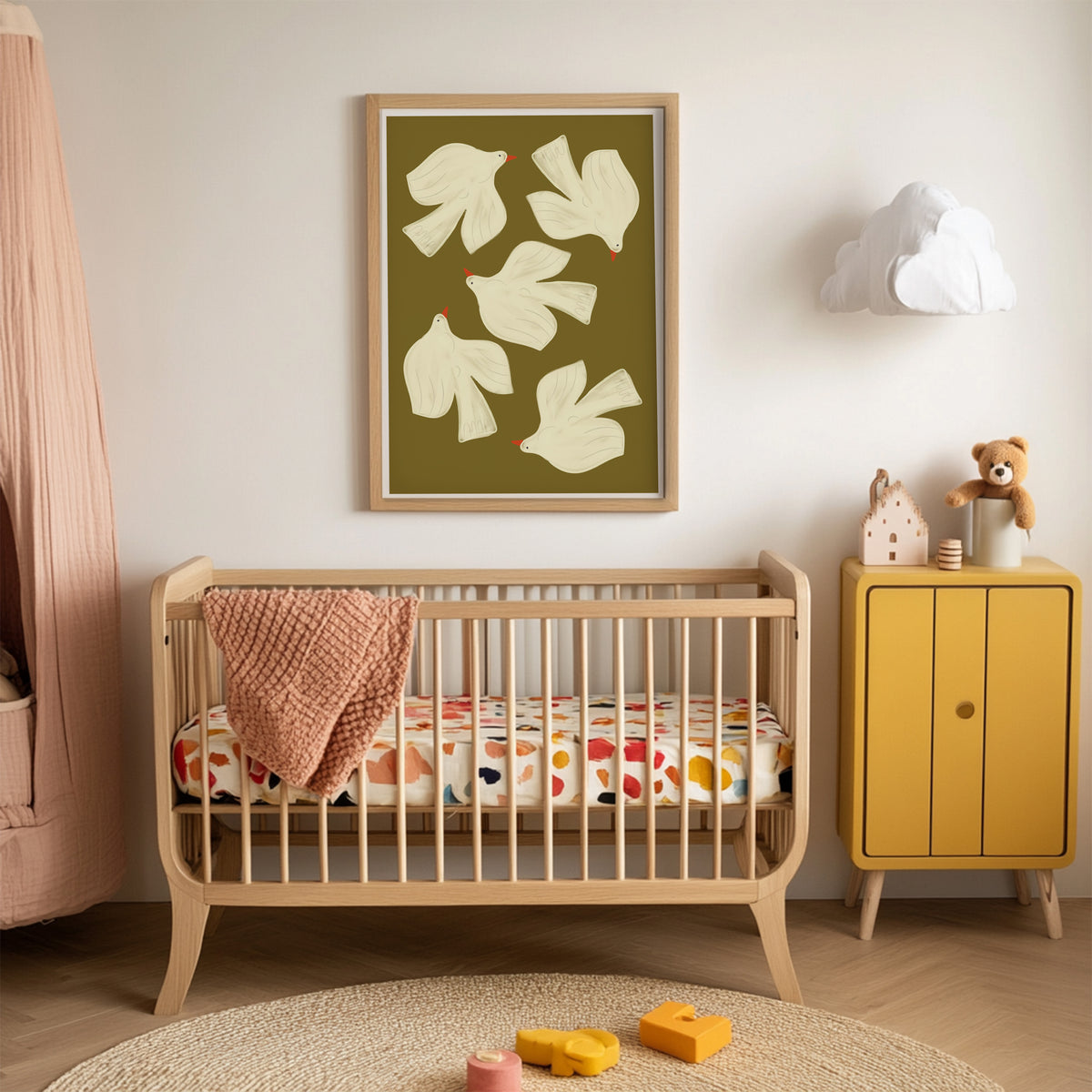 Nursery room with wooden crib, yellow cabinet, and floral artwork on the wall.