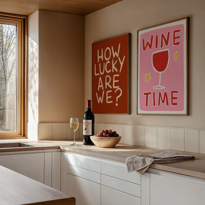 Modern kitchen with wine bottle, glasses, and decorative signs on the wall.