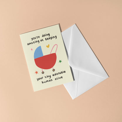 Greeting card with baby stroller illustration and text on a beige background