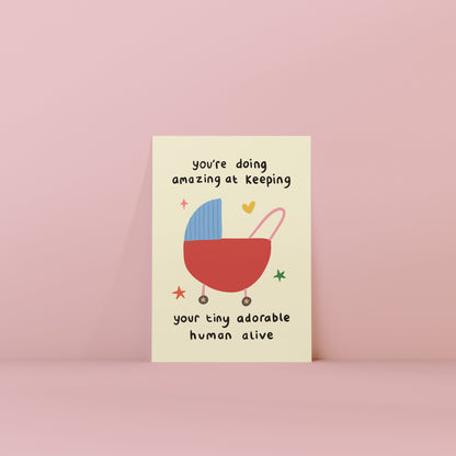 Card with a baby buggy illustration and text on a pink background