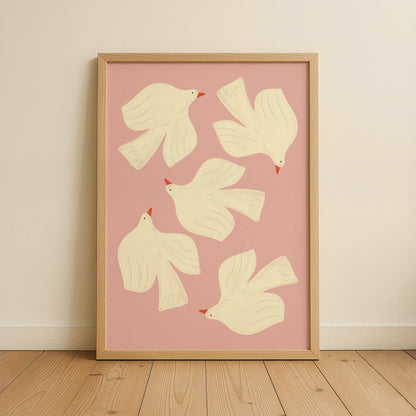 Framed artwork with white dove illustrations on a pink background, displayed on a wall.