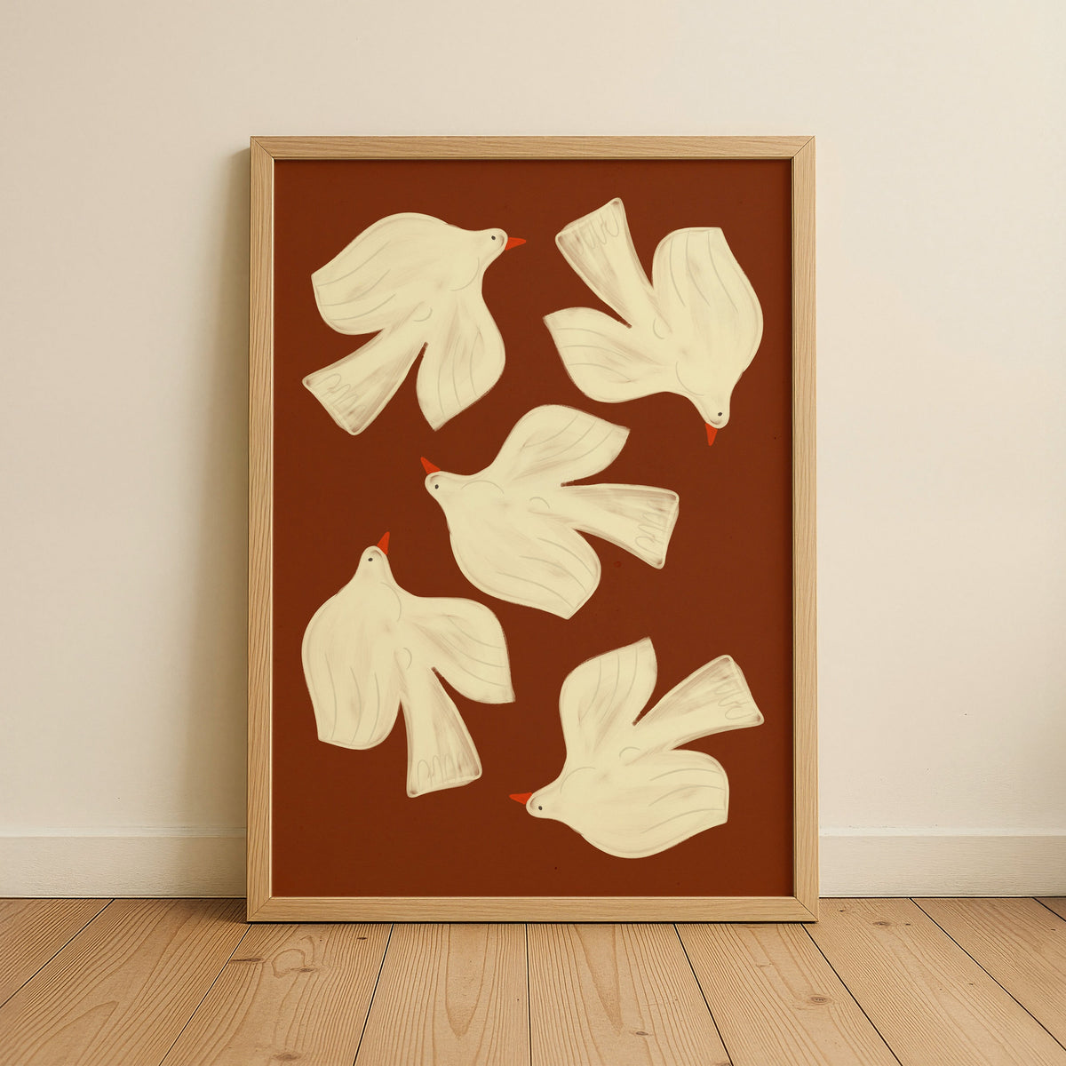 Framed artwork with white dove illustrations on a brown background, displayed on a wall.