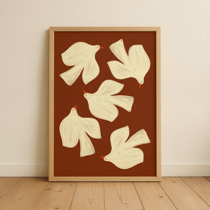 Framed artwork with white dove illustrations on a brown background, displayed on a wall.