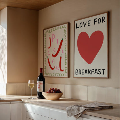 Modern kitchen with wine bottle, grapes, and two framed artworks on the wall.