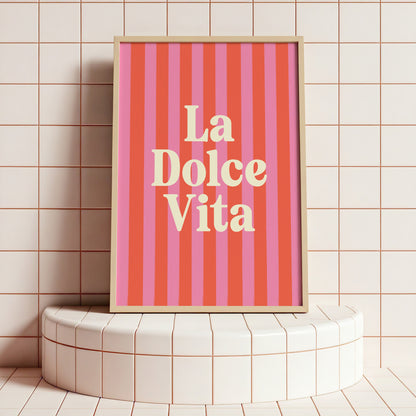 Framed 'La Dolce Vita' poster on a tiled wall