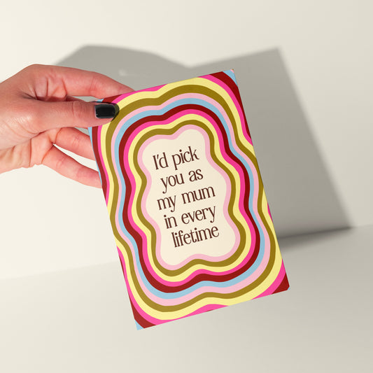Hand holding a colorful card with text on a light background