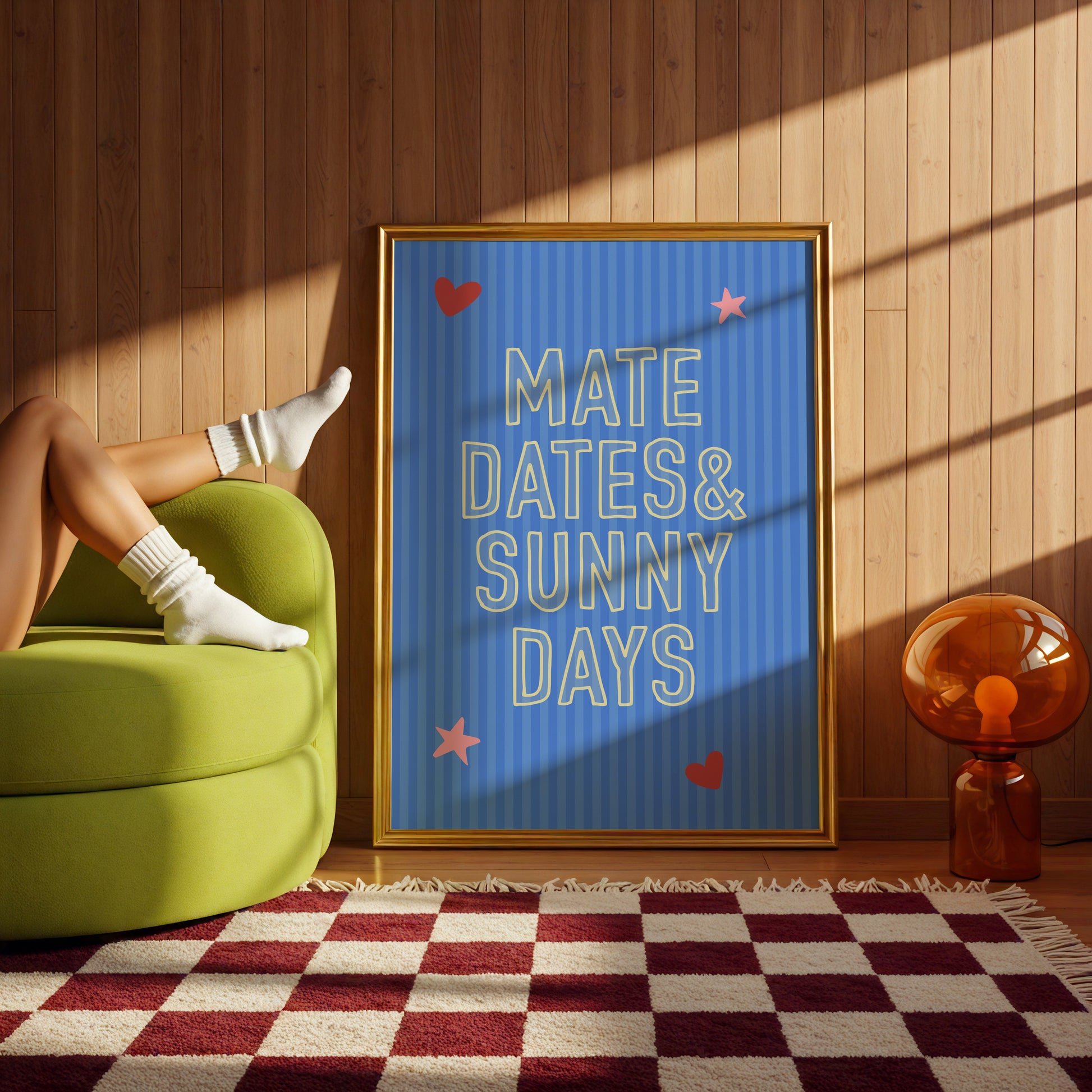 Person sitting on a green chair with a framed quote 'MATE DATES & SUNNY DAYS' in a room with wooden walls and a checkered rug.