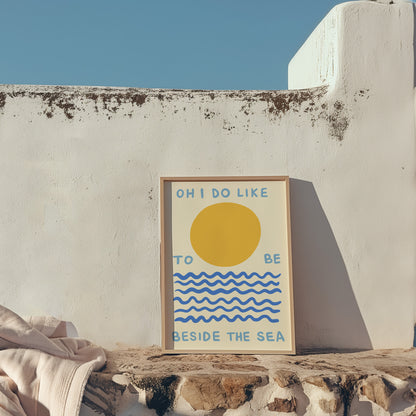 Framed artwork with a sun and wave design on a stone ledge against a white wall.