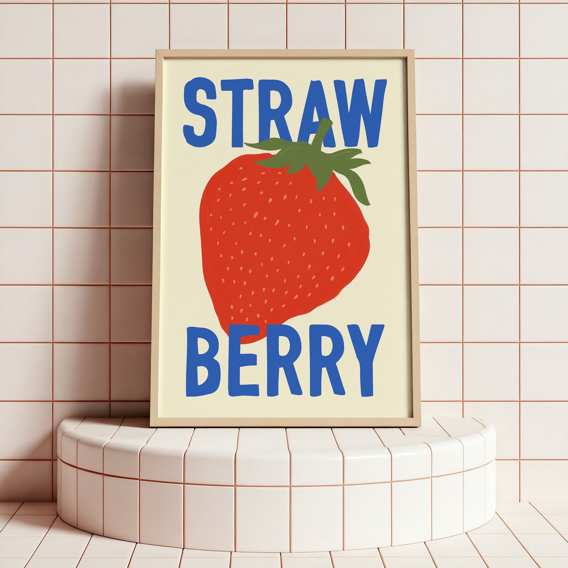 Framed artwork with a strawberry illustration and 'STRAW BERRY' text on a tiled wall.